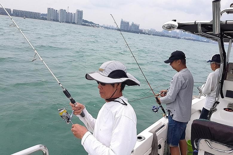 Anglers on a small boat in the open waters around the Southern Islands. Because of its deep waters, Bedok Jetty is a favourite spot with anglers hoping to reel in the big one. Mr Johnny Ng, 56, at Fishing Paradise at Orto.