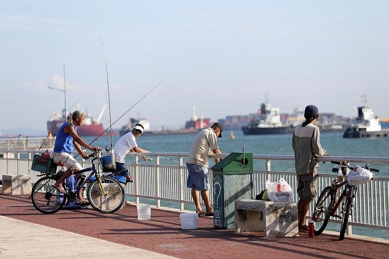 Anglers on a small boat in the open waters around the Southern Islands. Because of its deep waters, Bedok Jetty is a favourite spot with anglers hoping to reel in the big one. Mr Johnny Ng, 56, at Fishing Paradise at Orto.
