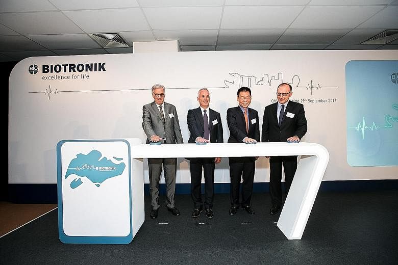 Biotronik, a leader in cardio- and endovascular medical technology, makes equipment like pacemakers (above). Its new Singapore facility (below) will be manufacturing components for its latest products. From left: Dr Michael Witter, Ambassador of the 