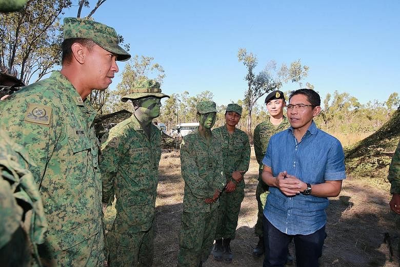 Dr Maliki (in blue shirt) with soldiers, including ME2 Muhammad Efendi Ismail (extreme left), at Exercise Wallaby in Australia on Wednesday. Behind him is exercise director, BG Chua Boon Keat (wearing beret).
