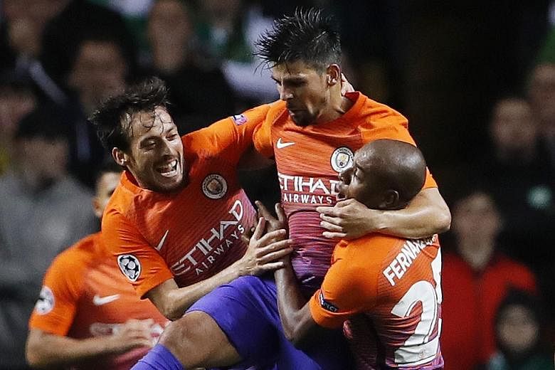 Manchester City's Nolito (centre) celebrates scoring their third goal with team-mates David Silva (left) and Fernandinho. The Premier League leaders had to equalise thrice to earn the point against Glasgow Celtic.