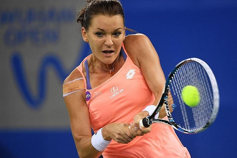 Reigning WTA Finals champion Agnieszka Radwanska hitting a backhand during her Wuhan Open quarter-final loss to Svetlana Kuznetsova yesterday. The Pole is fourth in the Road to Singapore standings.