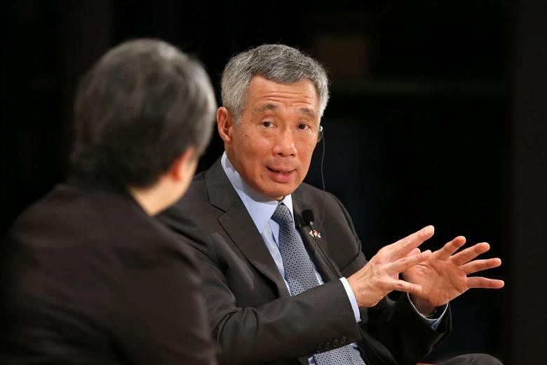 PM Lee speaking at the question and answer segment during the Special Session of the Nikkei 22nd International Conference on the Future of Asia at Imperial Hotel in Tokyo yesterday. Ms Sonoko Watanabe, editor-in-chief of the Nikkei Asian Review, was the m