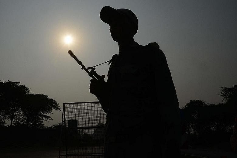A soldier from the Indian Border Security Force standing guard at the India-Pakistan border crossing in Wagah on Thursday. India yesterday evacuated thousands of people near the border in northern Punjab while villagers in parts of Kashmir were also 