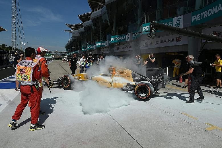 Renault driver Kevin Magnussen's car is engulfed in flames while being pushed back into the garage during first practice, forcing the Dane to make a hasty escape. The incident caused a 15-minute delay.