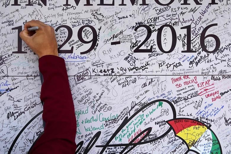 Top: A fan signing a tribute wall for American great Arnold Palmer, who died last Sunday aged 87, ahead of the Cup. Above: United States and European fans enjoying each other's camaraderie before the rivalry begins. Left: Team USA's Ryan Moore with h