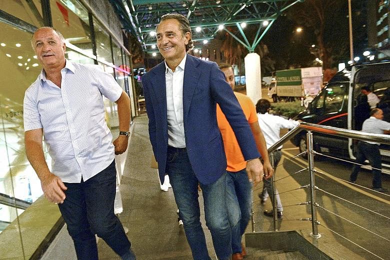 Cesare Prandelli (in blue) arriving at Forum The Shopping Mall with Luiz Felipe Scolari. Valencia executive director Anil Murthy (in orange) is behind them. They had dinner with Valencia owner Peter Lim yesterday.