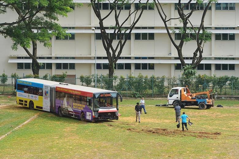 First a field, now a tennis court - buses have been ending up in the wrong places the past two days. An SBS Transit bus (right) yesterday evening crashed onto a tennis court when making a turn in Yio Chu Kang bus interchange, a day after an SMRT bend