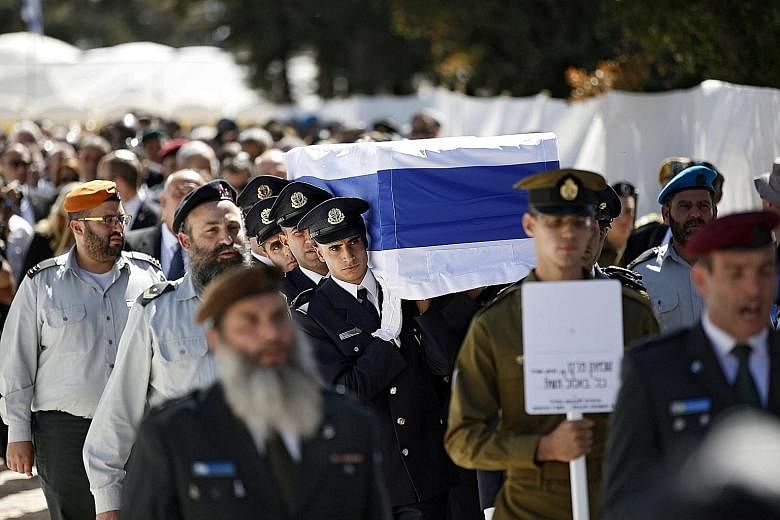 An honour guard carrying the coffin of Mr Shimon Peres yesterday.