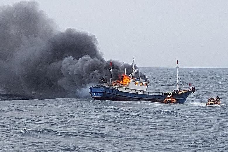 The Chinese fishing boat on fire in South Korean waters near the south-western port of Mokpo on Thursday. South Korea's coast guard had boarded it for illegal fishing.