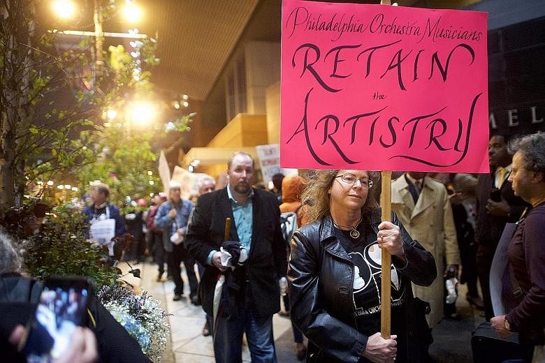 Musicians of the Philadelphia Orchestra on strike (above) over pay issues just before their season-opening gala concert in Philadelphia last Friday.