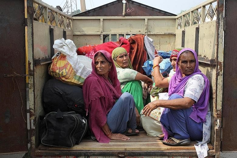 Indian villagers sitting inside a vehicle as they are evacuated from their village near the border with Pakistan. Tensions between the two states have risen rapidly, with Pakistan reacting furiously to Indian military raids that were carried out in r
