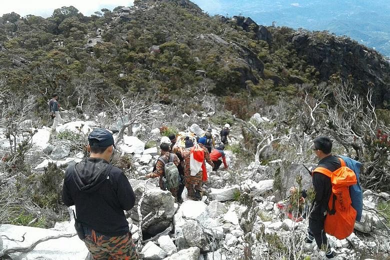 Rescuers taking Mr Woon Tai Kiang's body down Mount Kinabalu yesterday. He is believed to have fallen about 150m into a ravine after slipping off the trail, and died of serious head injuries, according to rescuers and police. Mr Woon was an avid and 
