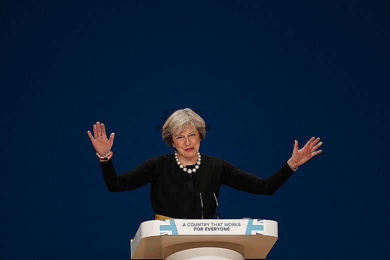Britain's Prime Minister speaking at the opening of the Conservative Party's annual conference yesterday. Some British politicians feared that triggering Article 50 so early could put pressure on Britain as elections in France and Germany next year c