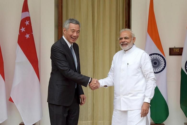 NEW DELHI, INDIA - JANUARY 25: Prime Minister Narendra Modi (R) shakes hand  with Prime Minister of Singapore Lee Hsien Loong (L) prior to their  bilateral meeting on the sidelines of India-ASEAN
