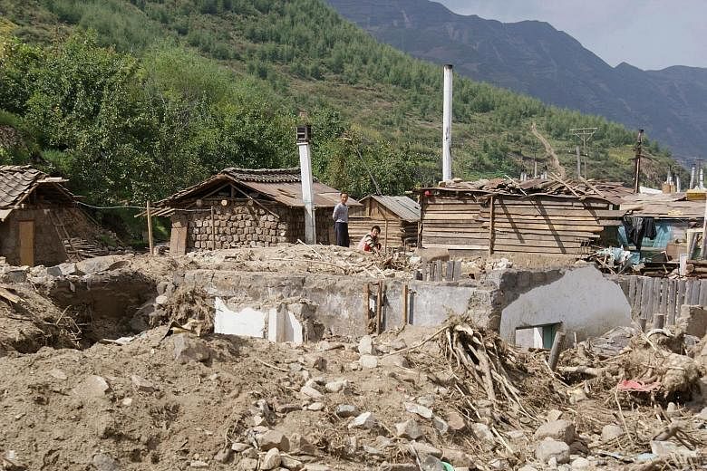 A handout photo taken on Sept 18 and released by Unicef DPRK showing homes damaged when the Tumen River burst its banks in August in Haksan Ri in the northern part of North Korea.