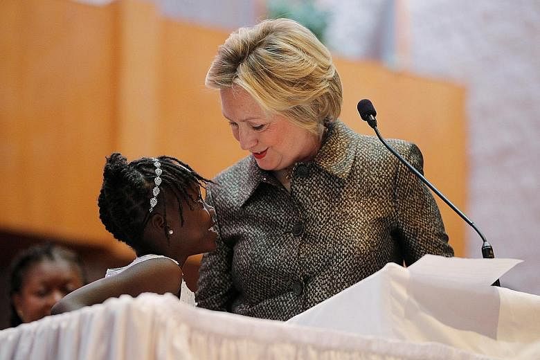 Zianna Oliphant, nine, joining Mrs Clinton at the pulpit in Little Rock AME Zion Church in Charlotte, North Carolina, on Sunday. Zianna had testified before the Charlotte City Council about violence in her community.
