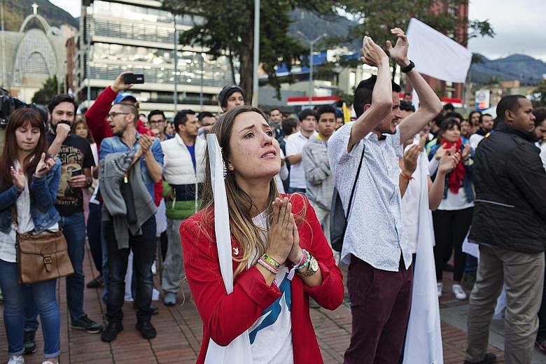 Colombians reacting to news of the rejection of a peace deal with rebel group Farc following a referendum in Bogota on Sunday. The vote risks renewing 52 years of war.