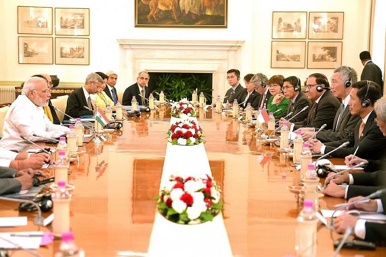 Mr Modi (far left) and PM Lee at a meeting in Hyderabad House yesterday. Mr Lee credited India's transformation and optimism about its prospects to Mr Modi's leadership and vision, while the Indian PM called Singapore a key partner on India's journey