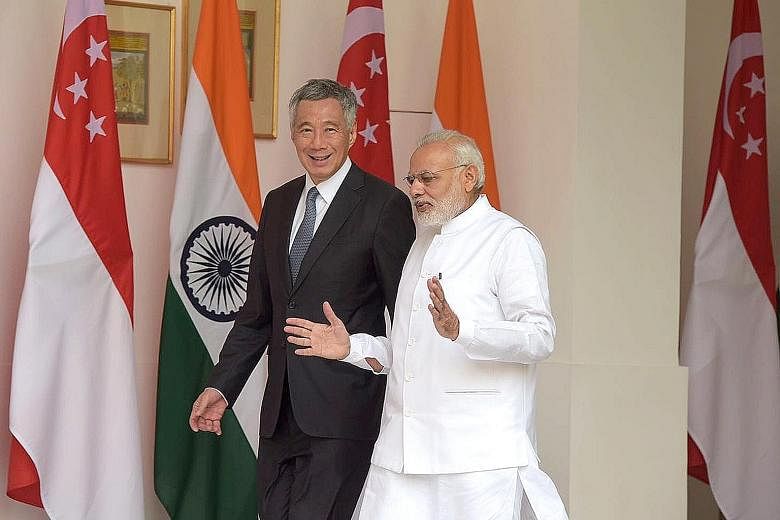 Mr Lee and Mr Modi at Hyderabad House in New Delhi yesterday. PM Lee is in India on a five-day working visit. During their meeting, the two leaders agreed to appoint senior ministers to facilitate investment flows and deepen financial cooperation bet