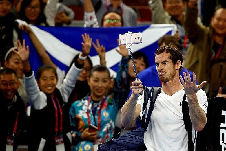 World No. 2 Andy Murray gesturing at a malfunctioning selfie stick after beating Italian Andreas Seppi at the China Open in Beijing yesterday.