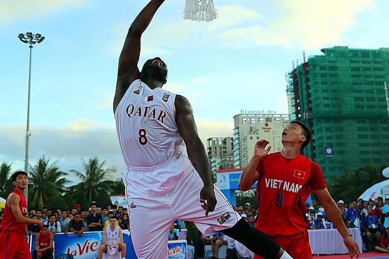 Qatar (in white) taking on Vietnam (in red) in a men's 3-on-3 basketball match at the Asian Beach Games in Vietnam's central coastal city of Danang. Qatar won gold after beating Mongolia in the final.