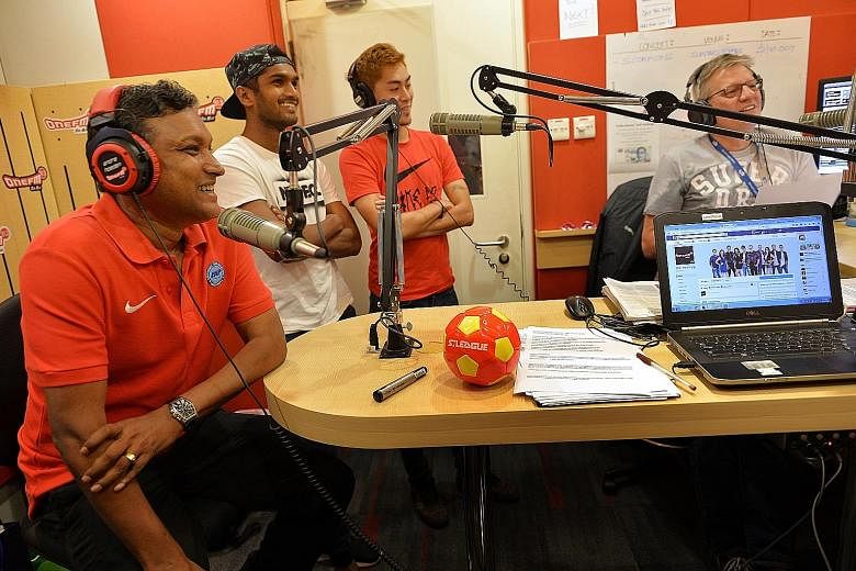 (From left) Singapore national caretaker coach V. Sundramoorthy and Lions midfielders Hariss Harun and Gabrial Quak having a chat with DJs Glenn Ong (not pictured) and the Flying Dutchman during ONE FM's morning show. They were promoting Friday's fri
