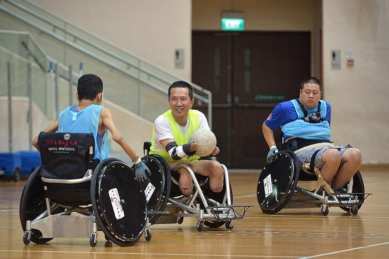 Mr Tan (centre) playing wheelchair rugby at Toa Payoh Stadium yesterday. Tomorrow, he will fly to Jakarta and represent Singapore in the 2016 Tafisa World Games, where his team will battle it out with participants from seven other nations.