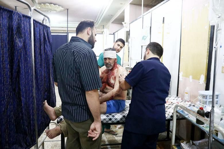 An injured Syrian man receiving treatment at a makeshift hospital on Monday, following reported air strikes in the rebel-held town of Douma, on the eastern outskirts of the capital Damascus. 