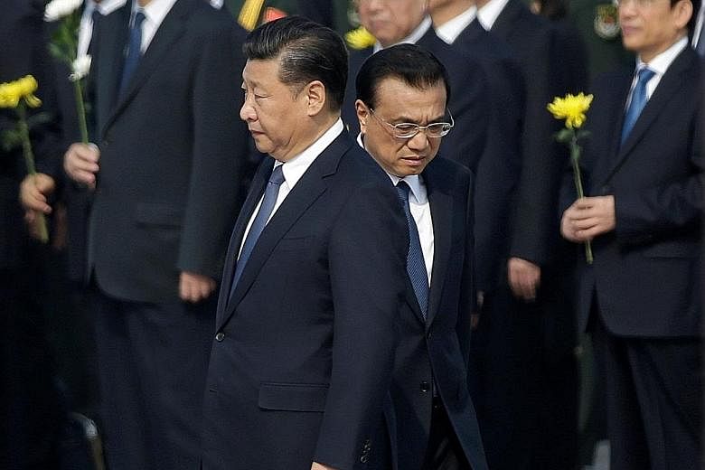 Chinese President Xi Jinping (left) and Premier Li Keqiang arriving at a tribute ceremony ahead of China's National Day last month. Mr Xi has not yet named a successor, and some analysts believe he wants to shunt Mr Li into a lesser job.