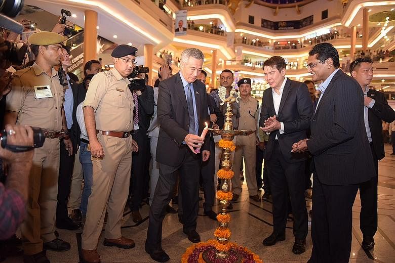 PM Lee at a light-up ceremony at Celebration Mall in Udaipur, India, yesterday. With him are CapitaLand group chief executive Lim Ming Yan (second from right) and CapitaLand Malls Asia's India country head B.V. Bharadwaja (right). CapitaLand yesterda