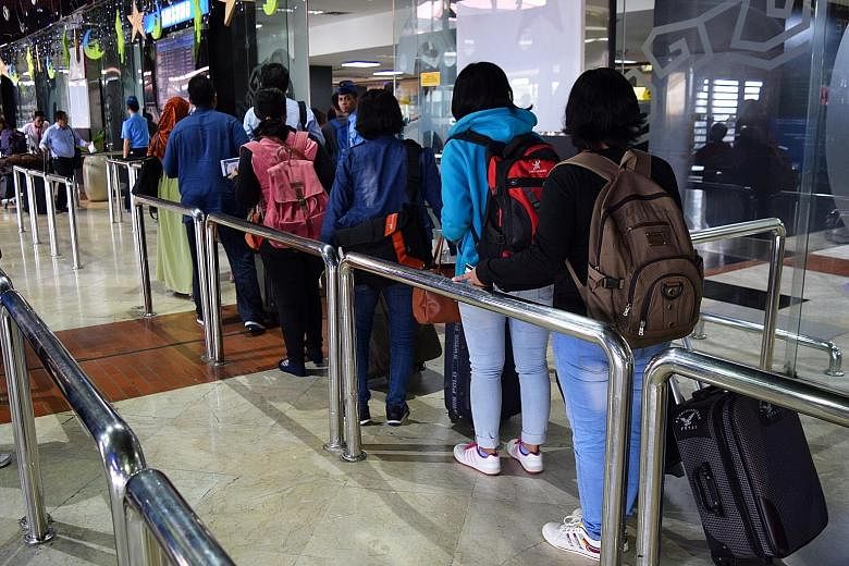 A group of Indonesian women leaving for Hong Kong from Jakarta's Soekarno-Hatta Airport to work as domestic helpers. Indonesian officials plan to visit Malaysia, Singapore, Brunei, Hong Kong and Taiwan from this month to discuss working conditions fo