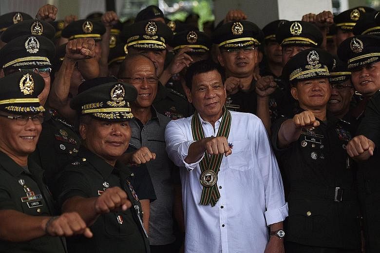 Mr Duterte (centre) with military officers during a "talk with the troops" session in Manila on Tuesday.
