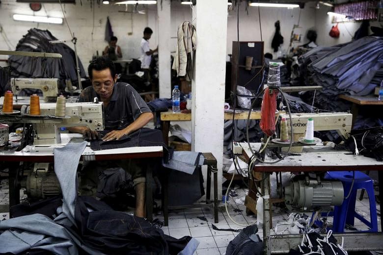 An employee stitching a pair of jeans at a small factory in Jakarta, Indonesia. While the country has comparatively few entrepreneurs, the idea of running their own businesses is gaining traction, especially among the young. The government hopes to increa