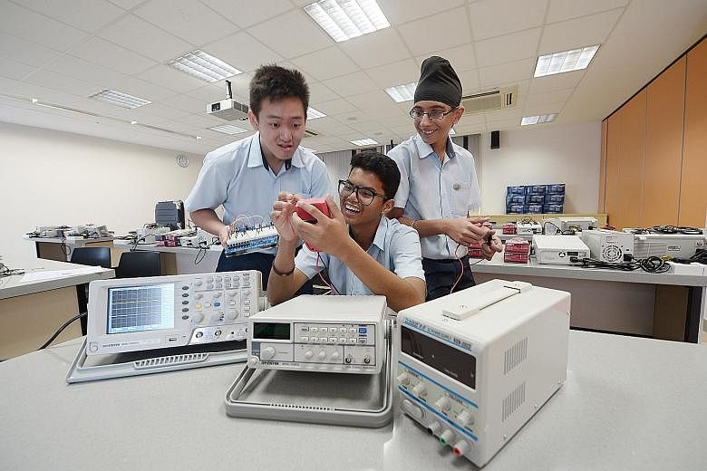 From left: Hong Kah Secondary students Juan Sebastian, Abdul Hafiz Abdul Hamid and Alwinderjit Singh Basant at an electronics lab. The school offers an elective in fundamentals of electronics in partnership with Ngee Ann Polytechnic.
