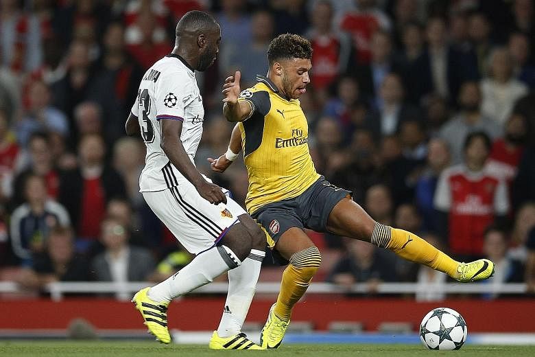 Arsenal midfielder Alex Oxlade-Chamberlain (right) going up against Basel defender Eder Balanta in the Champions League. He was a substitute in the 2-0 win and has yet to nail down a starting spot at Arsenal.