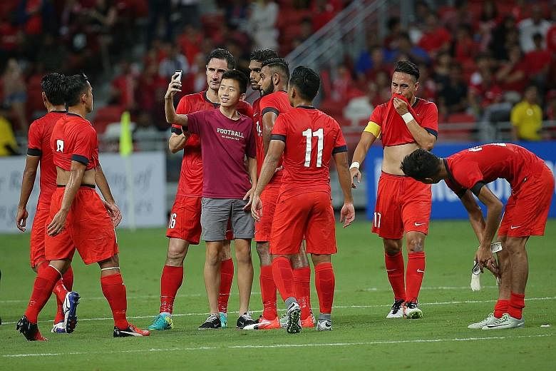 A young fan caused a minor stir when he walked up to the Singapore national team players to take a wefie after the whistle.
