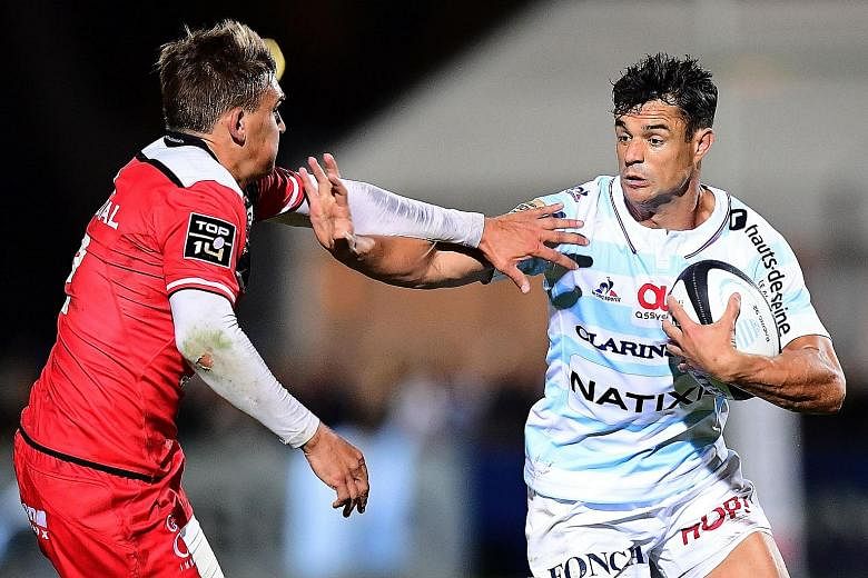 Racing's Kiwi fly-half Dan Carter trying to get past Toulouse's English fly-half Toby Flood in their match last month. He and two team-mates failed a drug test after the previous Top 14 season's final but the two Kiwis are said to have been allowed t