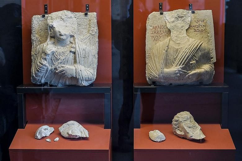 Above: Two busts whose faces were hammered away by ISIS members at the Palmyra museum in Syria, now part of an exhibition at the Colosseum in Rome. Right: The recreated human-headed winged bull from the Northwest Palace in Nimrud, Iraq, at the exhibi