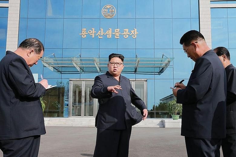 An undated picture released recently shows North Korean leader Kim Jong Un (centre) inspecting a water factory in Pyongyang. The North is said to be ready for another nuclear test at any time and some speculate it could mark the Oct 10 anniversary of