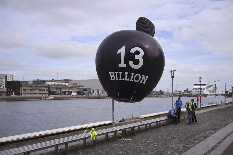 An "Apple" balloon used by protesters in Ireland to urge the government to accept the European Commission's €13-billion levy on the US tech giant for back taxes. Judicial actions against MNCs are now straining transatlantic relations. 