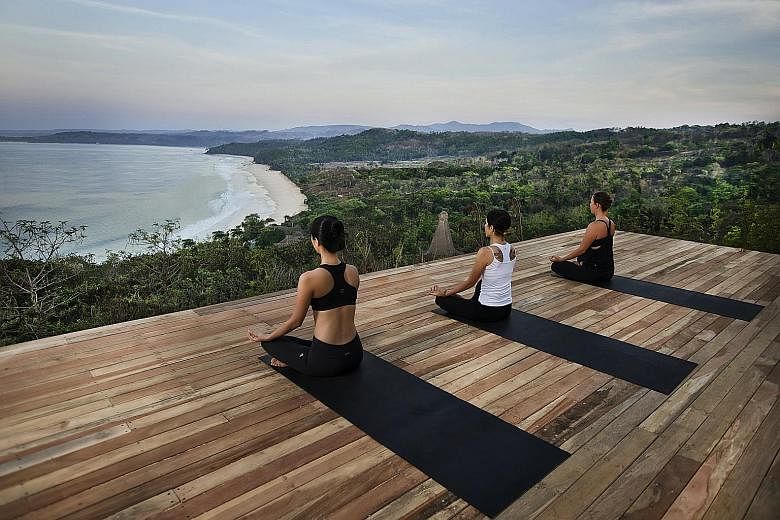 A yoga session (above) at the Nihiwatu Resort on Indonesia's Sumba Island. Customers entitled to Dynasty Travel's Christmas Comes Early lucky draw stand a chance to win a Celebrity Cruise to Alaska (left).