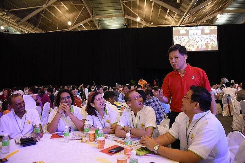 Mr Chan (in red) with grassroots leaders at the Singapore Expo. He described civic and volunteer groups as part of a "second wing" network, that is not part of the PA's traditional grassroots network but forms part of the social fabric. "Only when th