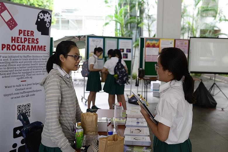 Far left: Year 5 student and peer helper Jeanne Tan, 17, manning a booth during Rl's Mental Health Awareness Week. Left: At ACS Independent, encouraging notes from teachers were placed outside exam venues.