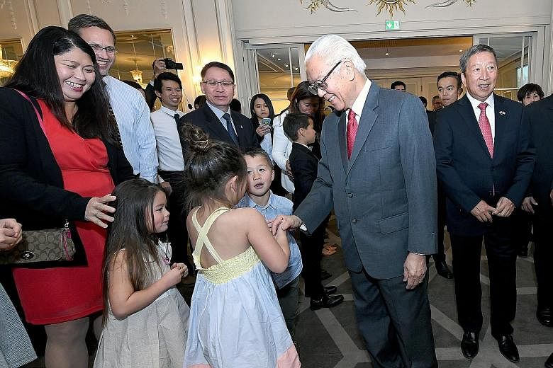 President Tony Tan Keng Yam mingling with Singaporeans and their families at a reception at Grand Hotel Oslo in Norway yesterday. Also present was Singapore's non-resident Ambassador to Norway Ng Ser Miang (at right).