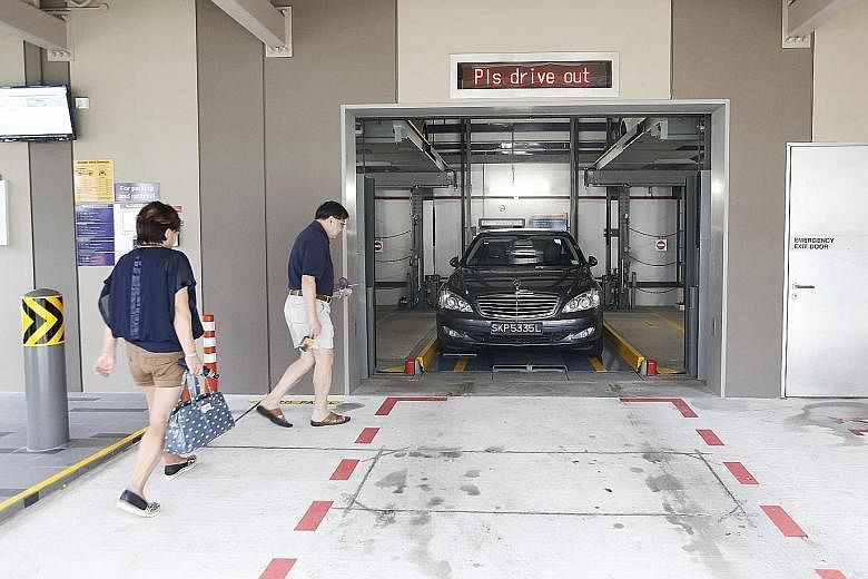 A couple collecting their car from a mechanised carpark in Yishun. While some users say the system is convenient and safe, others feel the waiting time is too long.