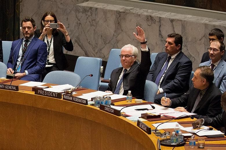 Russia's ambassador to the United Nations, Mr Vitaly Churkin, raising his hand to veto a resolution in the Security Council demanding an end to the bombing of Aleppo.