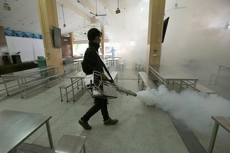 A worker spraying chemicals to kill mosquitoes in the Sathon district of Bangkok. Two Thai babies have been diagnosed with Zika-linked microcephaly.