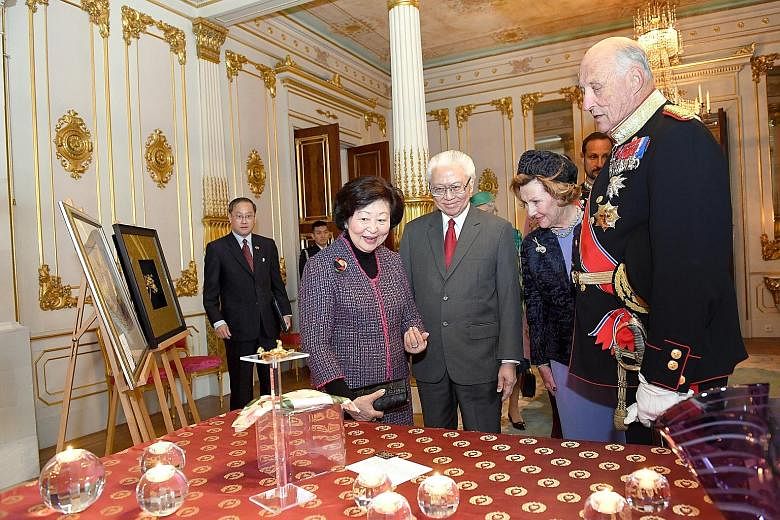 From left: Mrs Mary Tan, President Tony Tan Keng Yam and Norway's royal couple, Queen Sonja and King Harald V, admiring the gifts which they exchanged at the Royal Palace in Oslo yesterday.