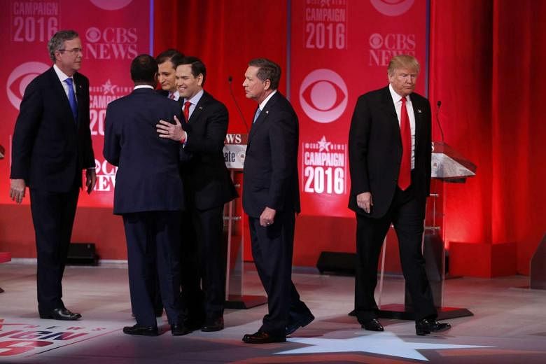 Mr Trump (far right) walking off the stage alone as his former rivals - (from left) Mr Jeb Bush, Dr Ben Carson, Senator Ted Cruz, Senator Marco Rubio and Governor John Kasich - gathered after a Republican presidential candidate debate in February. Mr Kasi